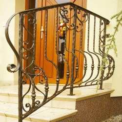 A wrought iron staircase handrail