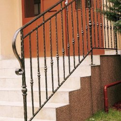 A wrought iron staircase handrail - house entrance