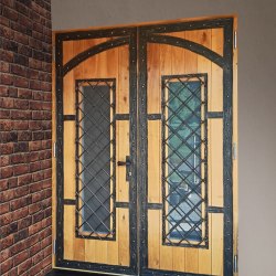 A wrought iron door with wood