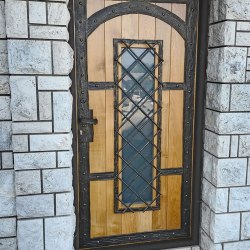 A wrought iron entrance door with wood