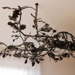 A hand-forged chandelier inspired by nature - candleholders and lamps
