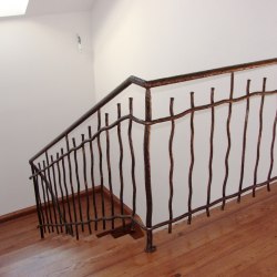 A hand forged railing - interior - stairs
