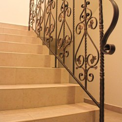 A wrought iron interior railing in a historical style