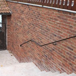 A wrought iron exterior handrail and gate