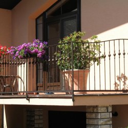 An exterior wrought iron balcony railing