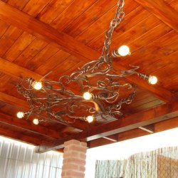 A ceiling wrought iron light in a garden summer house