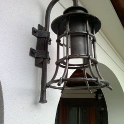 A wrought iron lamp with a shade - Forged candleholders and lamps