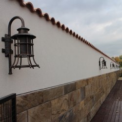 A wrought iron lamp with a shade - Forged candleholders and lamps