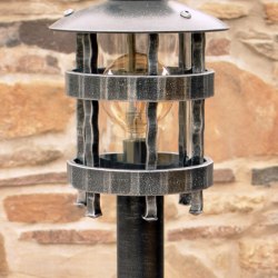 A wrought iron standard lamp Historical - a garden lamp