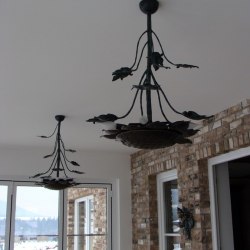 A wrought iron sunflower as a chandelier - Forged candleholders and lamps