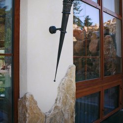 A wrought iron torch in a summer house