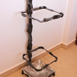 A wrought iron umbrella stand