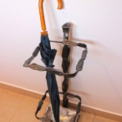 A wrought iron umbrella stand