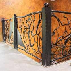 Hand wrought iron interior staircase railing - Roots