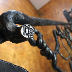 Ručne kované zábradlie v horskej chalupe - detail zábradlia s logom Ukovmi